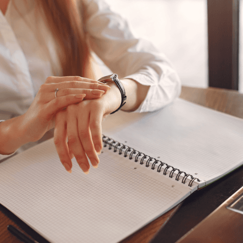 a busy person checking their watch